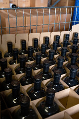 Storage of bottles of cognac spirit aged in French oak barrels in shop in distillery house, Cognac white wine region, Charente, Segonzac, Grand Champagne, France