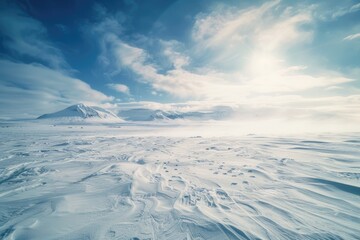 A vast, snow-covered plain with a clear blue sky