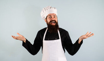 Professional culinary. Closeup portrait of happy male chef, cook or baker in uniform, hat and...