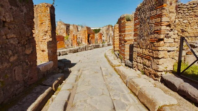 Via Consolare, with its famous stepping stones and chariot ruts in Pompeii, Naples, Campania, Italy, an ancient Roman city buried by Mount Vesuvius in 79 AD