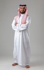 A saudi man wearing thob standing on background. isolated on background