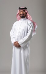 A saudi man wearing thob standing on background. isolated on background