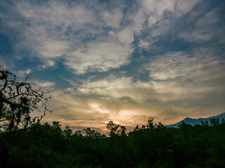 The beautiful sky of the dawn over the forests and farmlands of the highlands, in the eastern Andean mountains of central Colombia.