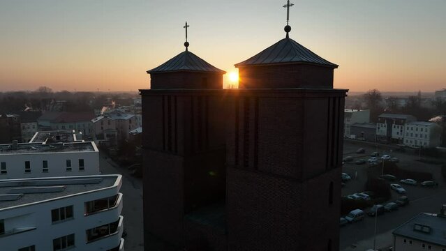 Drone shot of a church with the sun in the background in Cottbus.