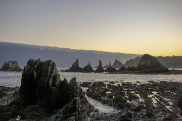 Fototapeta premium dawn lights near Cudillero, Spain, in Gueirua beach