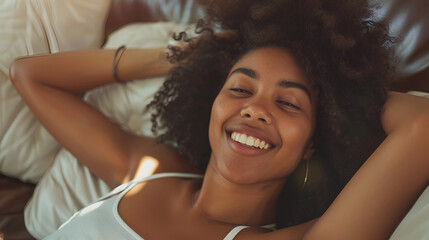 Happy afro american woman relaxing on the sofa at home - Smiling girl enjoying day off lying on the couch - Healthy life style, good vibes people and new home concept