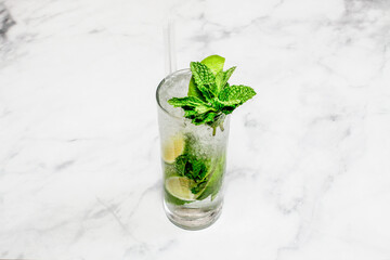 Cocktail Mojito decorated on the bright table.