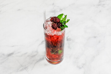 Cocktail Blackberry Mojito decorated on the bright table.