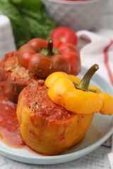 Delicious stuffed bell peppers on white wooden table