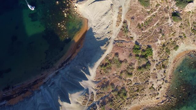 Qarraba Bay flat rock cape Malta, Aeriale stablishing shot in the morning sunlight showing hiking trekking path and two beaches on both side. High quality 4k footage