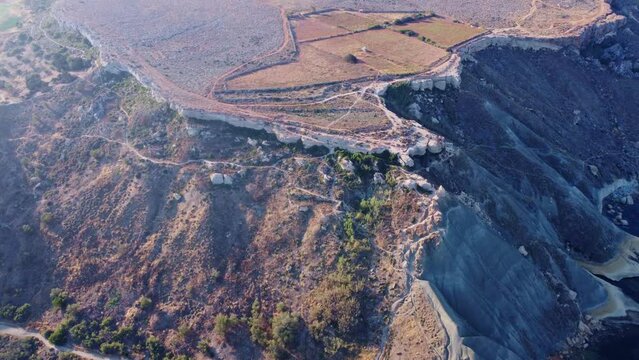 Qarraba Bay flat rock cape Malta, Aeriale stablishing shot in the morning sunlight showing hiking trekking path and two beaches on both side. High quality 4k footage