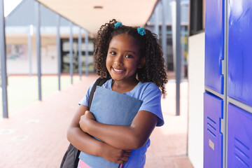 Biracial girl stands confidently at school