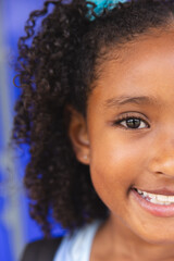 Close-up of a smiling biracial girl at school