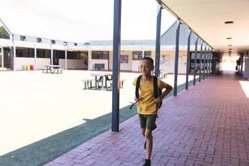 Biracial boy smiles at school, with copy space