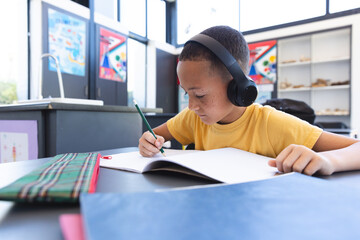 Biracial boy focuses on schoolwork at school