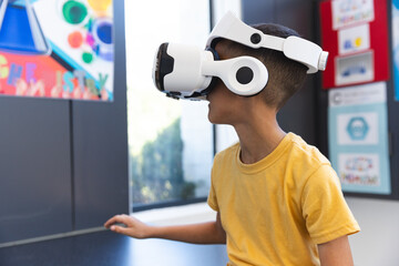 Biracial boy explores virtual reality at school