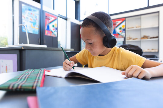 Biracial boy focuses on schoolwork at school