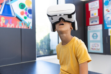 Biracial boy explores virtual reality in a school setting