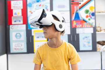 Biracial boy explores virtual reality in a classroom at school