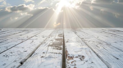 Weathered white wooden plank against sun rays in overcast skies