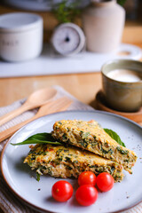 Baked omelet with tomatoes and coffee on the table for a healthy ketogenic diet.