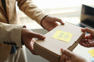 Businessman Giving Cardboard Box Written Thank You On Sticky Note. Businessman Giving Present to Partners at Office. 