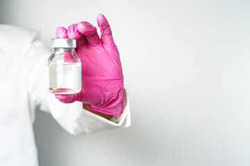 virus vaccine bottle for injection in hand of doctor or Technician scientist