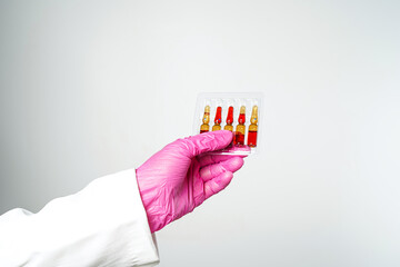 doctor or scientist holding ampules medicine vaccine and bottle for injection