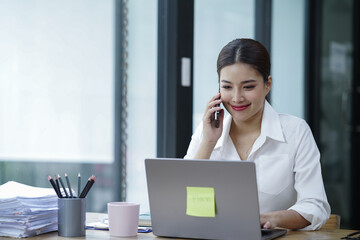 The Asian female business professional displayed a cheerful expression in her office.