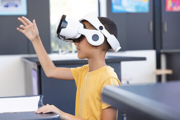 Biracial boy explores virtual reality in a classroom