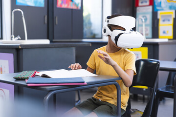 Biracial boy explores virtual reality in a classroom at school