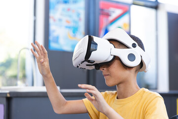 Biracial boy explores virtual reality at school