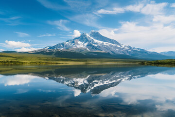 Majestic mountain peak reflects tranquil flowing water


