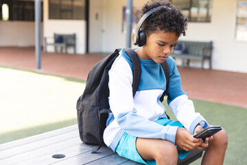 Biracial boy enjoys music on school grounds