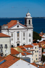 Fototapeta premium View of the beautiful skyline of Lisbon, Portugal, with red roofed, colorful houses in the Alfama district during a sunny day