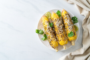 barbecue and grilled corn with cheese and lime