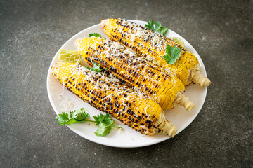 barbecue and grilled corn with cheese and lime