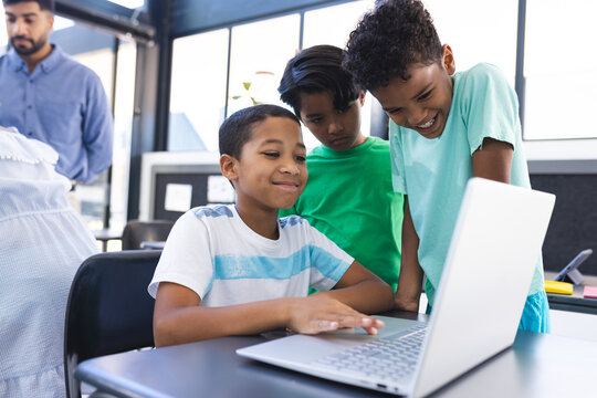 In school, diverse students are focusing on laptop in the classroom