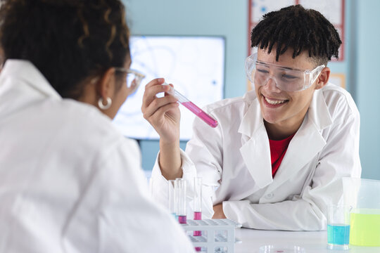 Teenage biracial boy and teenage girl in a high school lab