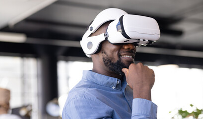 Young African American man wearing virtual reality headset in business office