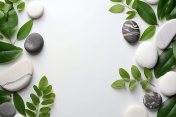 Zen natural stones and green herb leaf isolated on white copy space background. Spa and massage background concept