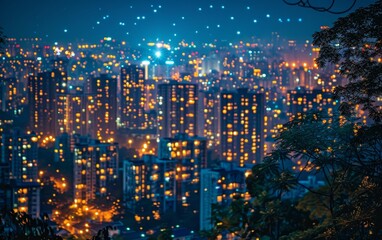 Obraz premium Vibrant cityscape at night with illuminated skyscrapers and glowing lights, capturing the bustling urban energy in a stunning view.