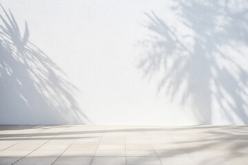 Minimalistic light background with blurred foliage palm shadow on white wall