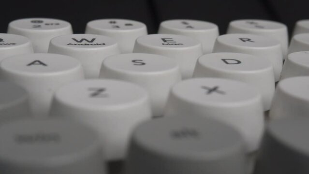 horizontal panning close up shot of round keyboard buttons