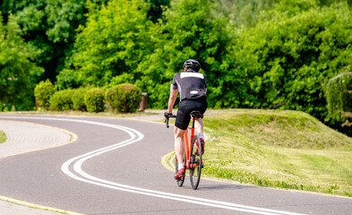 Cyclist ride on the bike path in the city Park
