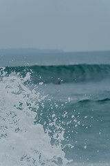 Ocean wave splashing with water droplets in the air