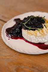 Close-up of Baked Brie with Blueberry Compote and Fresh Herbs