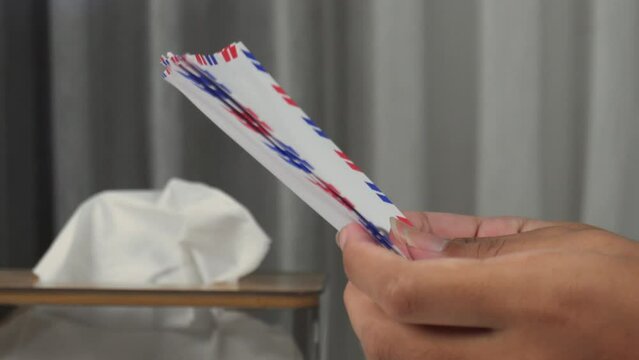 side view of hands sorting envelopes
