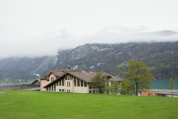 Brienz town on Lake Brienz by Interlaken, Switzerland, with snow covered Alps mountains in background