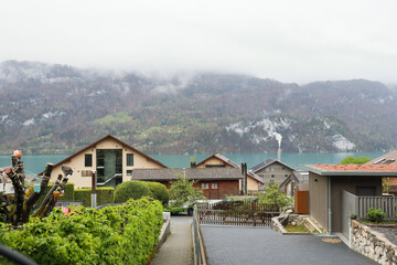 Brienz town on Lake Brienz by Interlaken, Switzerland, with snow covered Alps mountains in background